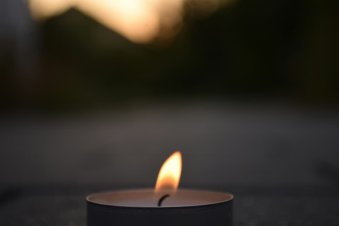 A tea light glowing in the dark